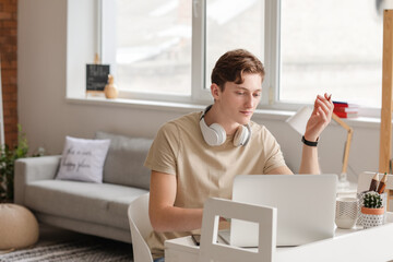 Young man studying online at home