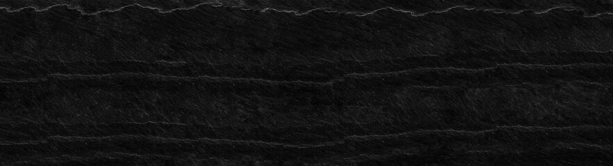 Black rock background. Dark gray stone texture. Black grunge background. Mountain close-up. Distressed backdrop.