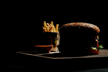 Silhouette of hamburger with french fries and sauce