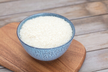 Fototapeta na wymiar A bowl of rice on a cutting board