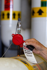 worker applying small valve lockout