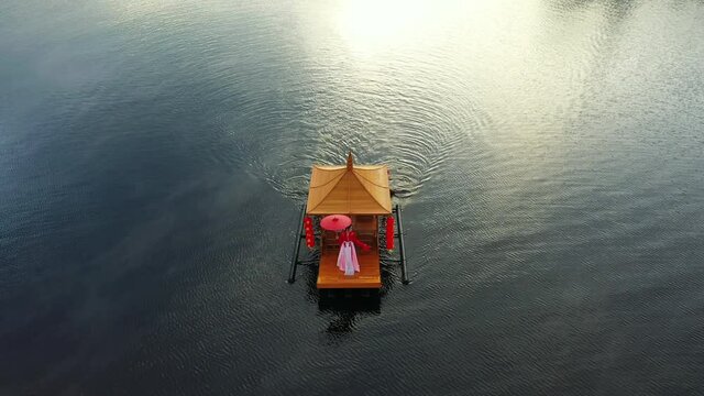 Asian woman wearing chinese traditional dress on a boat at Ban Rak Thai village, Mae hong son province.