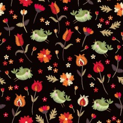Embroidery design. Seamless pattern with red and orange flowers and green birds. Textile print.