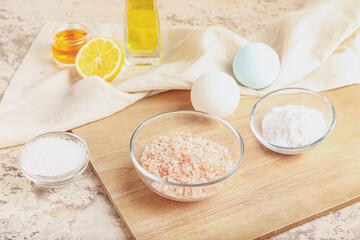 Board with ingredients for homemade cosmetics on grunge background