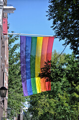 The LGBT flag is placed on the facade of the house