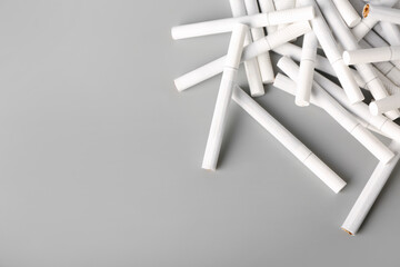 Many cigarettes on grey background