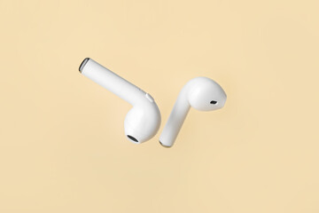 Modern earphones on color background