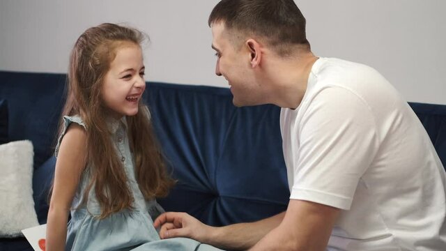 Little girl congratulating dad with Fathers day