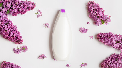 White bottle on white table background. Care about clean and soft face, hands, legs and body skin. Women daily beauty product. Copy space. Beauty and health concept