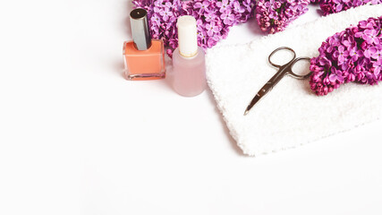 Flat lay composition with personal care products with branches of lilac on white table.background. Nails care. Manicure, pedicure beauty salon concept. Space for text