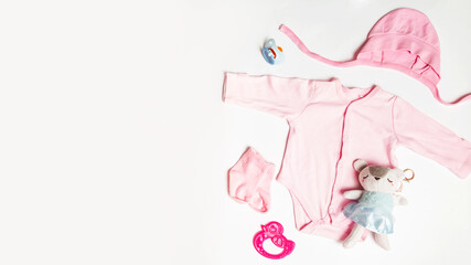 Baby accessories. Flat lay composition with child clothes and space for text on white table background. Motherhood concept