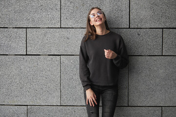 Woman wearing black sweatshirt or hoodie for mock up, logo designs or design prints with with free...