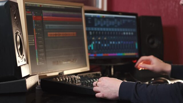 Sound operator hands at the volume control panel