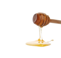 Honey pouring from wooden dipper on white background