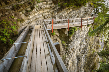 Adrenaline walking trail following historic irrigation channel on the cliffs Bisse du Ro close to...