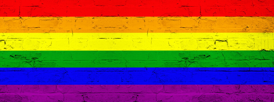 LGBT Background - Brick wall painted with rainbow flag - wood texture