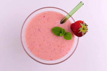 
A glass of cold banana strawberry smoothie on a white background.
Flat lei.