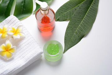 Cosmetic bottle containers with green herbal leaves and white flowers, Blank label for branding mock-up, Natural beauty product, Spa, wellness, massage, concept