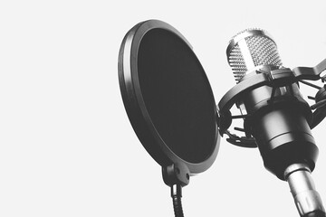Black and white photograph of a microphone recording singing for the studio.