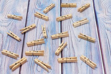 Wooden clothes pins on a wooden background