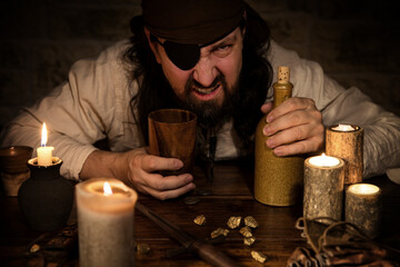 bad pirate with a bottle of rum sitting on a medieval table with old decoration