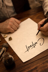 Closeup, Man sign a contract with a quill, concept business in the medieval