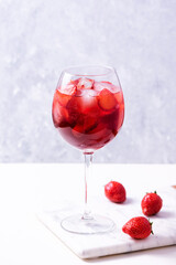Wine glass of strawberry alcohol aperol or daiquiri cocktail.