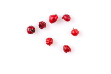 red peppercorns on white