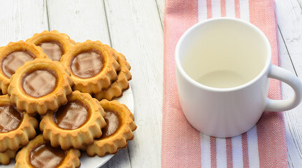 White empty cup, kitchen cotton napkin on light wooden background, close-up. Concept of breakfast, afternoon tea. Top and side view.