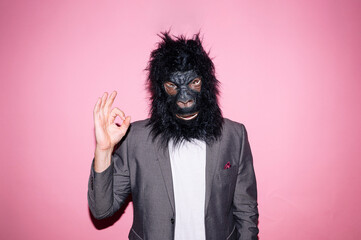 Gesture man wearing gorilla mask and making OK sign with hand
