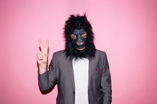 Gesture Man Wearing Gorilla Mask And Making V Sign With Hand