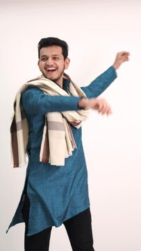Indian man dancing cheerfully on white backgound