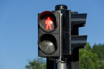 Red light for pedestrians on the blue background.