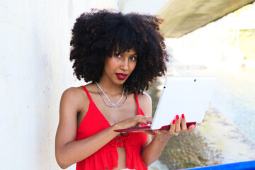 beautiful afro-american woman in a video conference with laptop. The woman is having fun while explaining what they are talking about. Telework concept. Video call