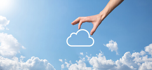 Male hand holding house icon on blue background. Property insurance and security concept.Real estate concept.Weather conditions, cloudiness.Banner with copy space