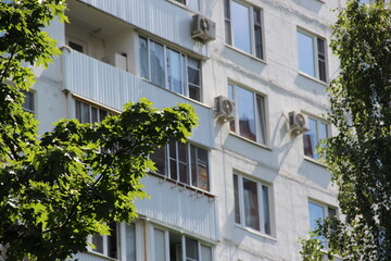 Fototapeta na wymiar The facade of a gray panel residential building. City apartments