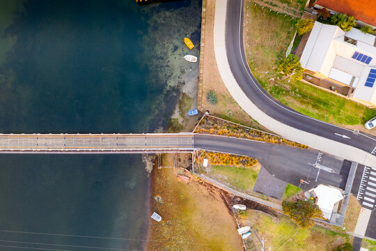 Aerial view over a fork in the road going over a bridge
