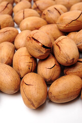 Peeled pecan nuts closeup, isolated on white background