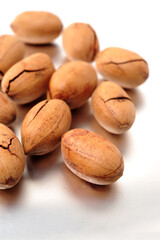 Peeled pecan nuts closeup, isolated on white background