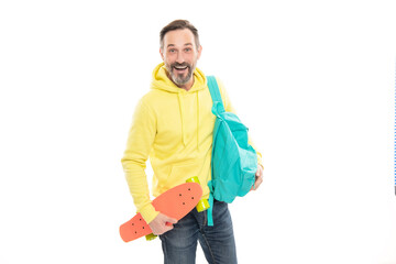 happy mature man hipster in hoody with backpack and penny board isolated on white, skateboarding.