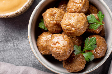  Traditional swedish meatballs with creamy sauce on gray background top view close up