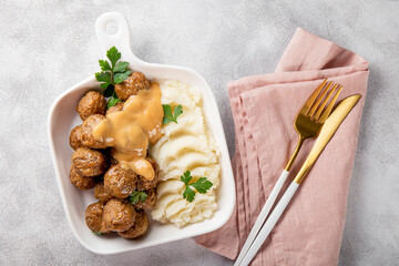  Traditional swedish meatballs with creamy sauce and mashed potatoes on gray background top view - obrazy, fototapety, plakaty
