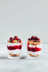 close-up of chia pudding with currant granola yogurt on gray background