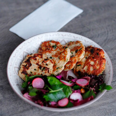 chicken patties and salad in a bowl