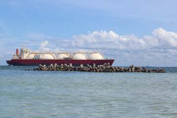 Fototapeta na wymiar tankers or ships carrying natural gas through the Jakarta sea and breakwaters