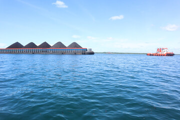 a tugboat pulling a coal pontoon in the sea area of ​​Jakarta, Indonesia