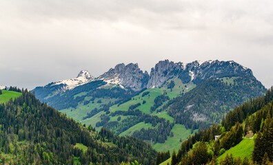 Fototapeta na wymiar View on alps mountain, green fields. Kanton Fribourg, Freiburg nearby Weissenbach, Jaun, Boltigen, Bulle, Bern, Thun. Good hiking tourist way. Switzerland.