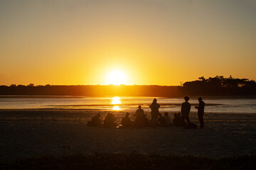 Group of People on a Beach enjoying the Sunset on Summer in Noosa, Queensland, Australia