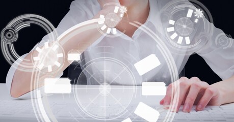 Multiple round scanners against mid section of woman using computer against black background