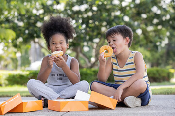 Portrait of happy kids enjoy eating donut around the house.Multiethnic friends,Children Friendship Togetherness Smiling Happiness Concept.